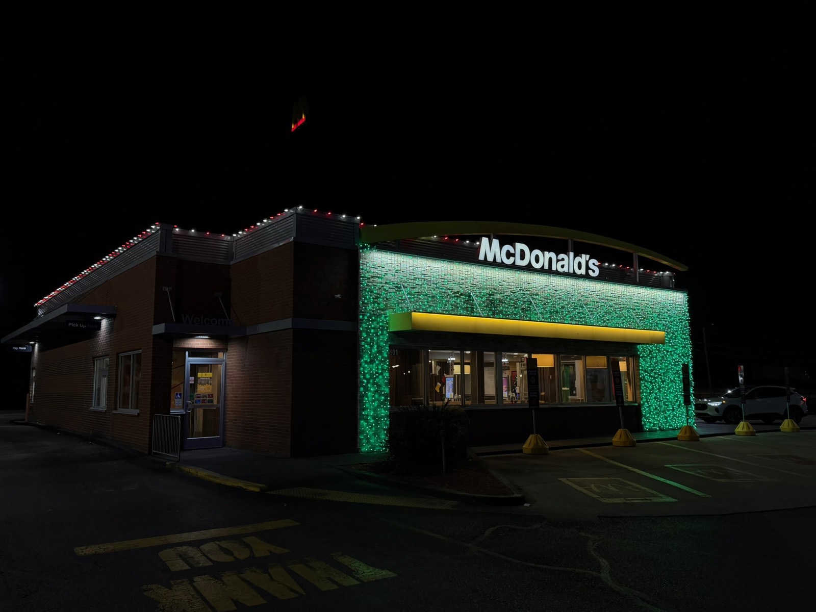 McDonalds restaurant front wrapped in green light curtains with a red and white roofline, Bowling Green KY